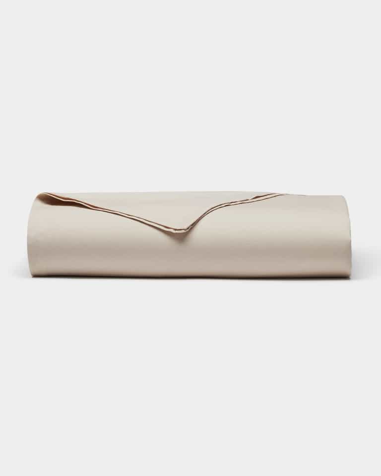 The Cozy Earth Soft-Wash Cotton Flat Sheet, neatly folded with one corner turned over to display its smooth texture and edges, is shown against a plain white background.|Color:Driftwood