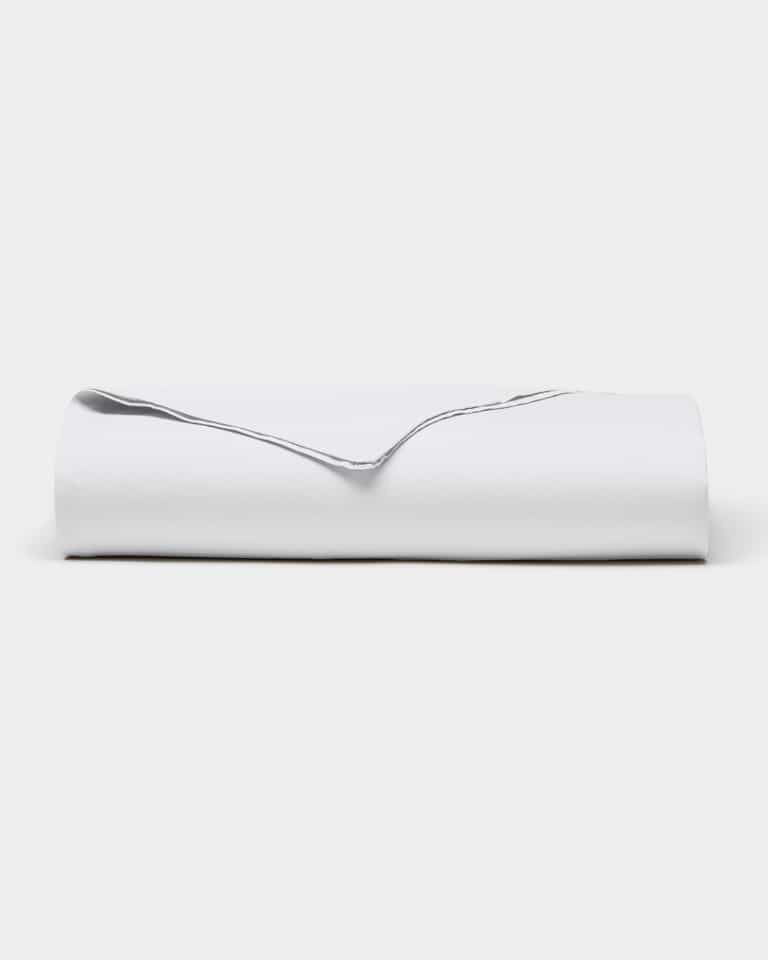 The Cozy Earth Soft-Wash Cotton Flat Sheet is neatly folded and displayed against a plain, light background.|Color:White