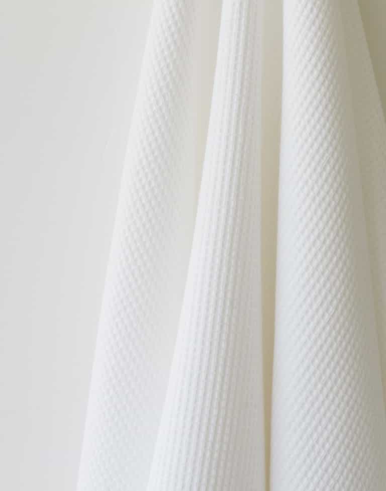 Waffle Bath Towel in the color White. Photo of White Waffle Bath Towel taken as a close up of the White Waffle Bath Towel. The picture shows only the towel |Color: White