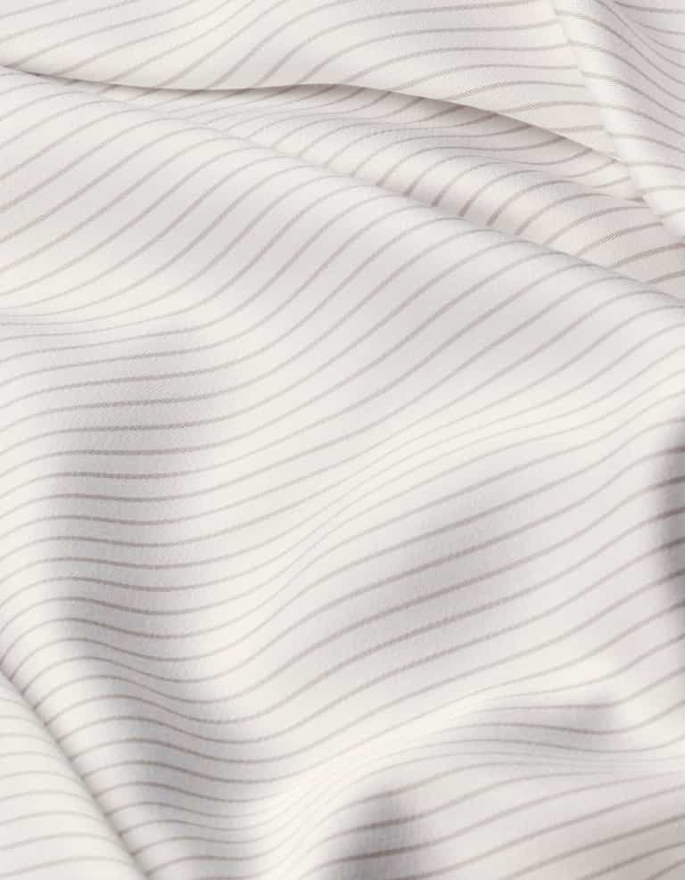 Close-up of Cozy Earth Bamboo Sheet Set’s white fabric with thin, evenly spaced light gray horizontal stripes, featuring soft folds and a smooth texture.|Color:Driftwood Pinstripe