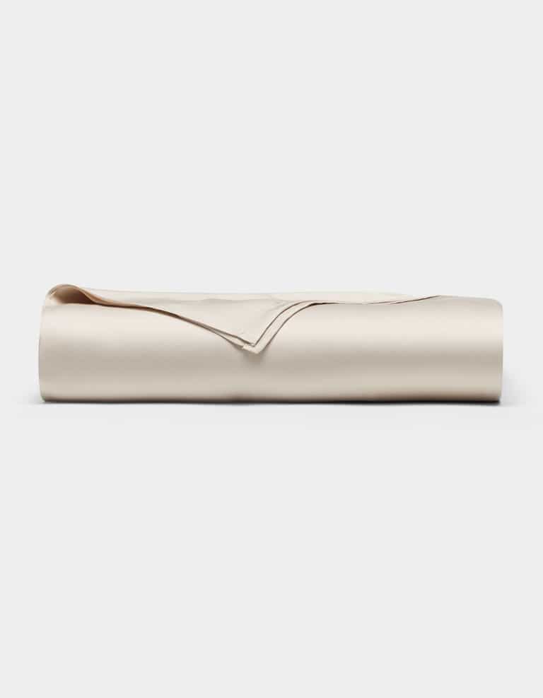 A neatly folded Cozy Earth Bamboo Flat Sheet in light beige or cream, displayed against a plain white background.|Color:Oat