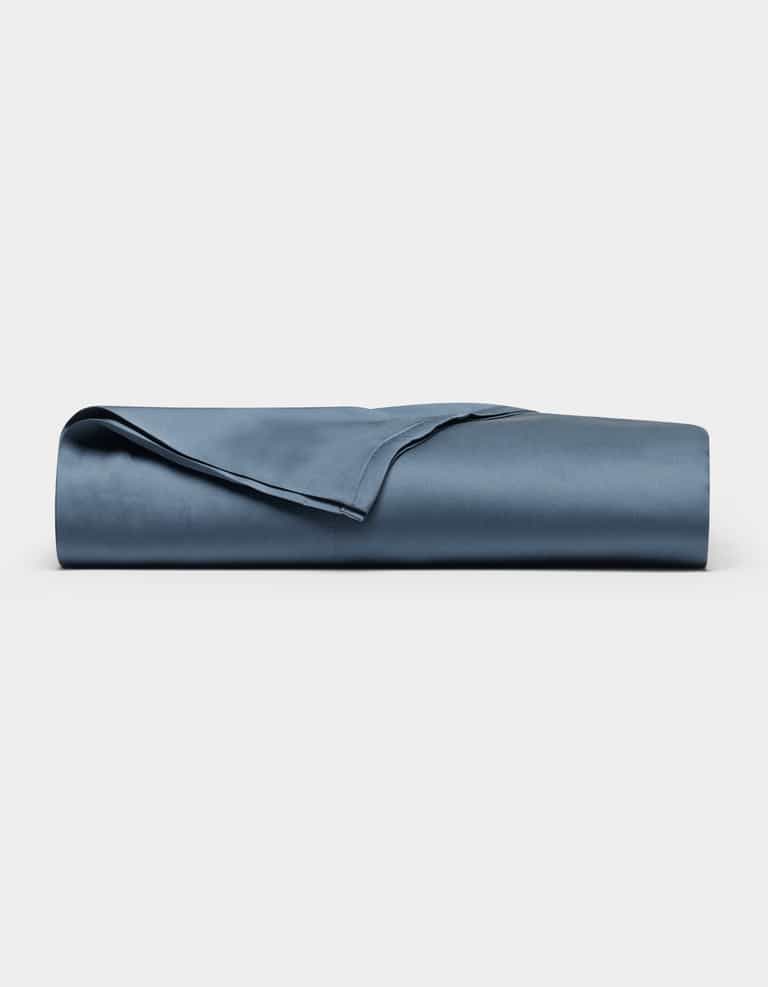 The Cozy Earth Bamboo Flat Sheet, neatly folded and smooth in navy blue, is displayed against a plain white background.|Color:Pacific Blue