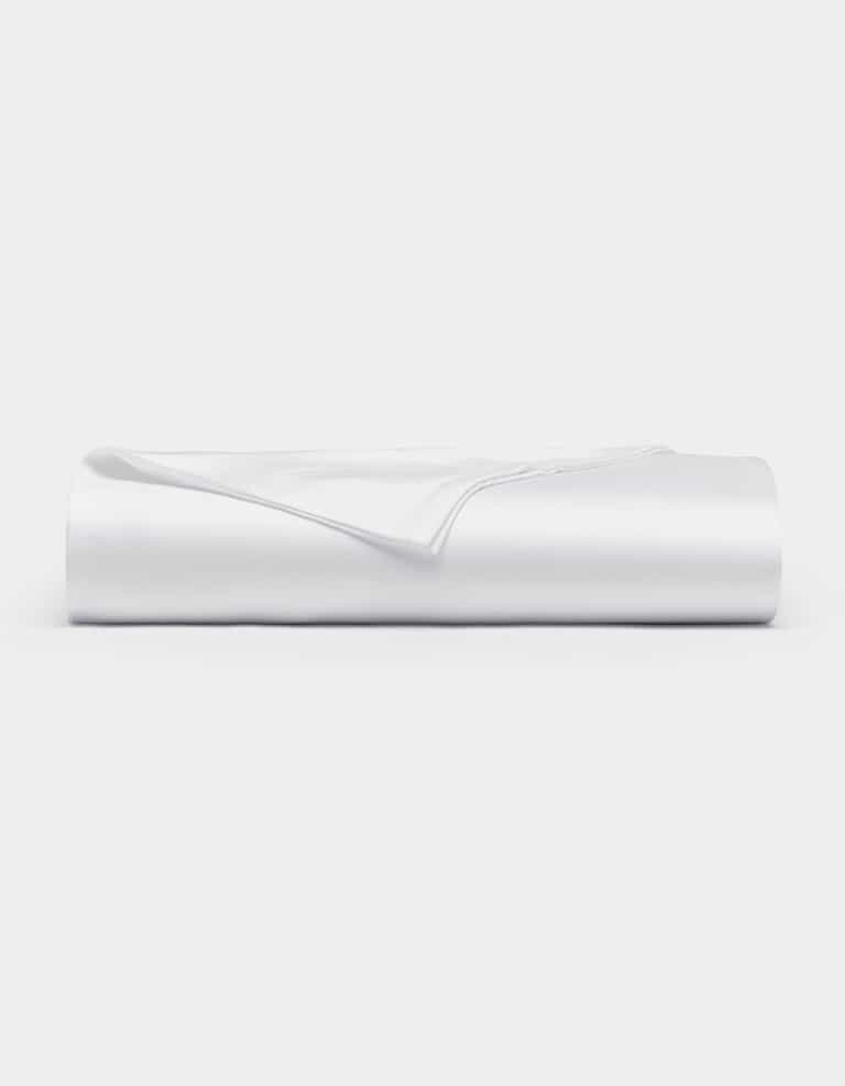 A neatly folded Cozy Earth Bamboo Flat Sheet in white rests on a flat surface against a plain white background.|Color:White
