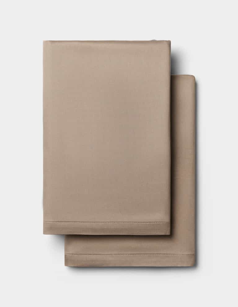 Two neatly folded Cozy Earth Bamboo Pillowcases are stacked on a plain white background.|Color:Walnut