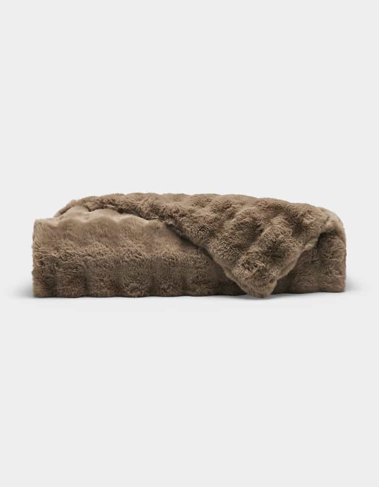 The Bubble Cuddle Blanket by Cozy Earth, made of soft brown faux fur, is folded neatly against a plain white background.|Color:Walnut
