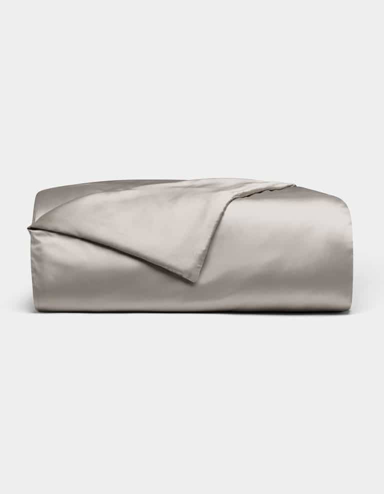 The Cozy Earth Bamboo Duvet Cover, shown neatly folded in light gray with a smooth, shiny satin finish, is displayed on a plain white background.|Color:Dove Grey