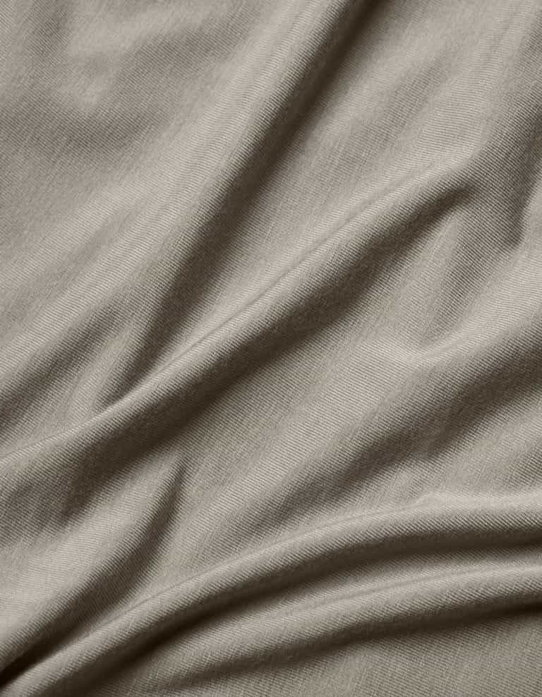 Close-up of the Cozy Earth Bamboo Jersey Flat Sheet in light grey, highlighting its smooth texture, subtle weave pattern, and soft folds.|Color:Stone
