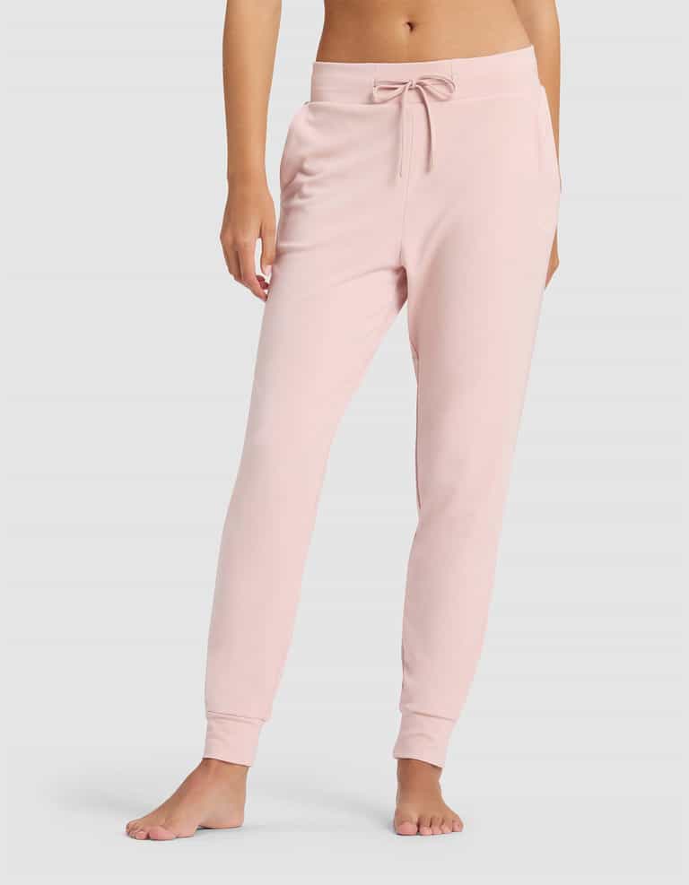 A woman stands barefoot against a plain light background, showing only the lower half of her body in Cozy Earth's Women's Brushed Bamboo Jogger Pant—light pink, with a drawstring waist.|Color:Dusty Rose