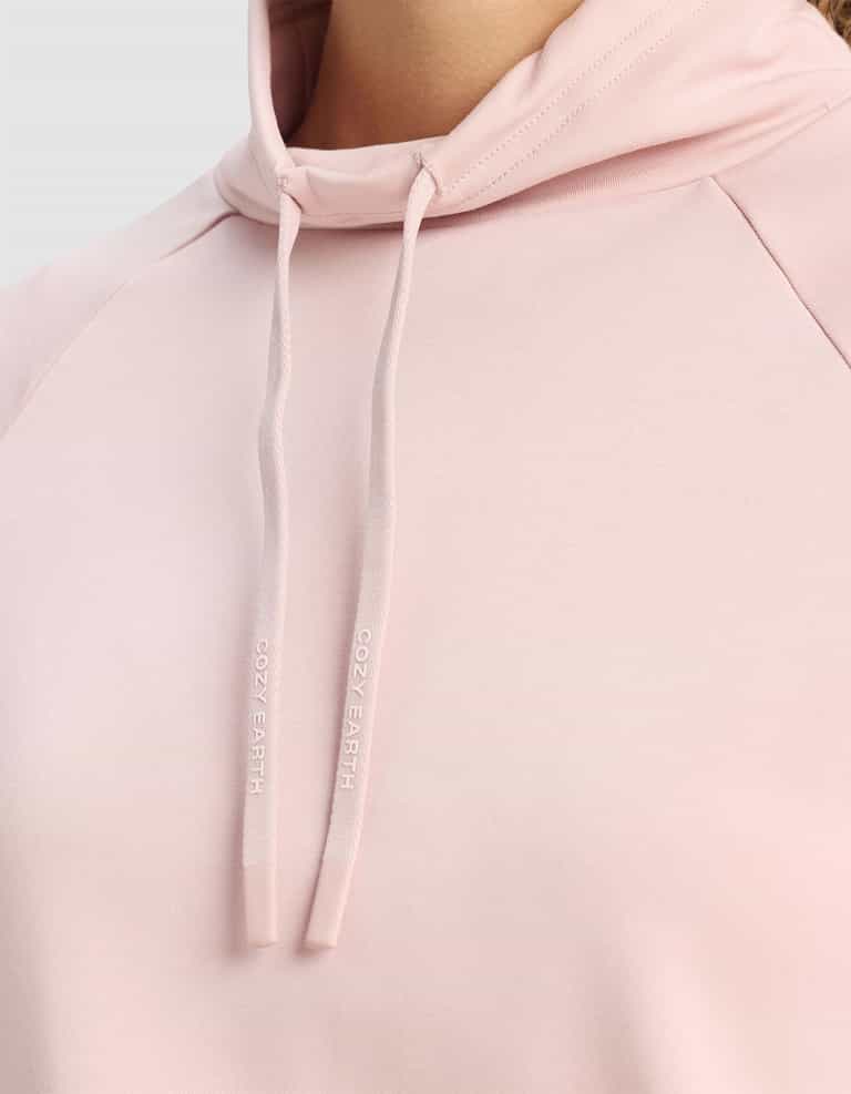 Close-up of Cozy Earth’s Women's Brushed Bamboo Mock Neck in light pink, with branded "COZY EARTH" drawstrings. The soft, smooth fabric stands out against a neutral gray background.|Color:Dusty Rose