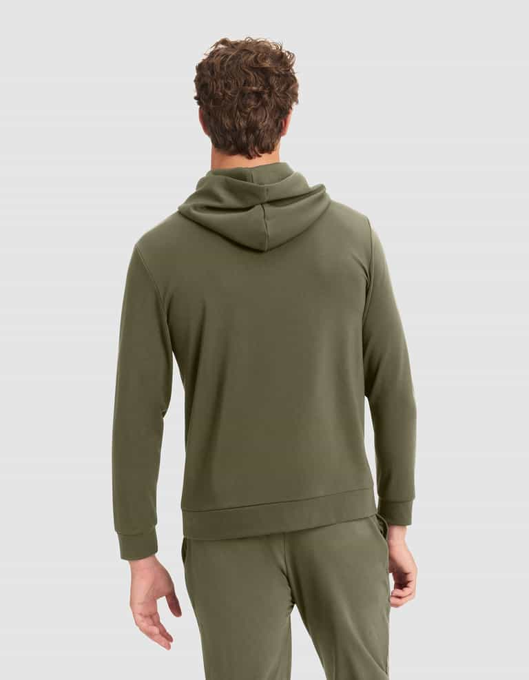 A man faces away, wearing the Cozy Earth Men's Brushed Bamboo Hoodie in olive green with matching sweatpants, his left hand relaxed at his side. The background is light gray. |Color:Olive