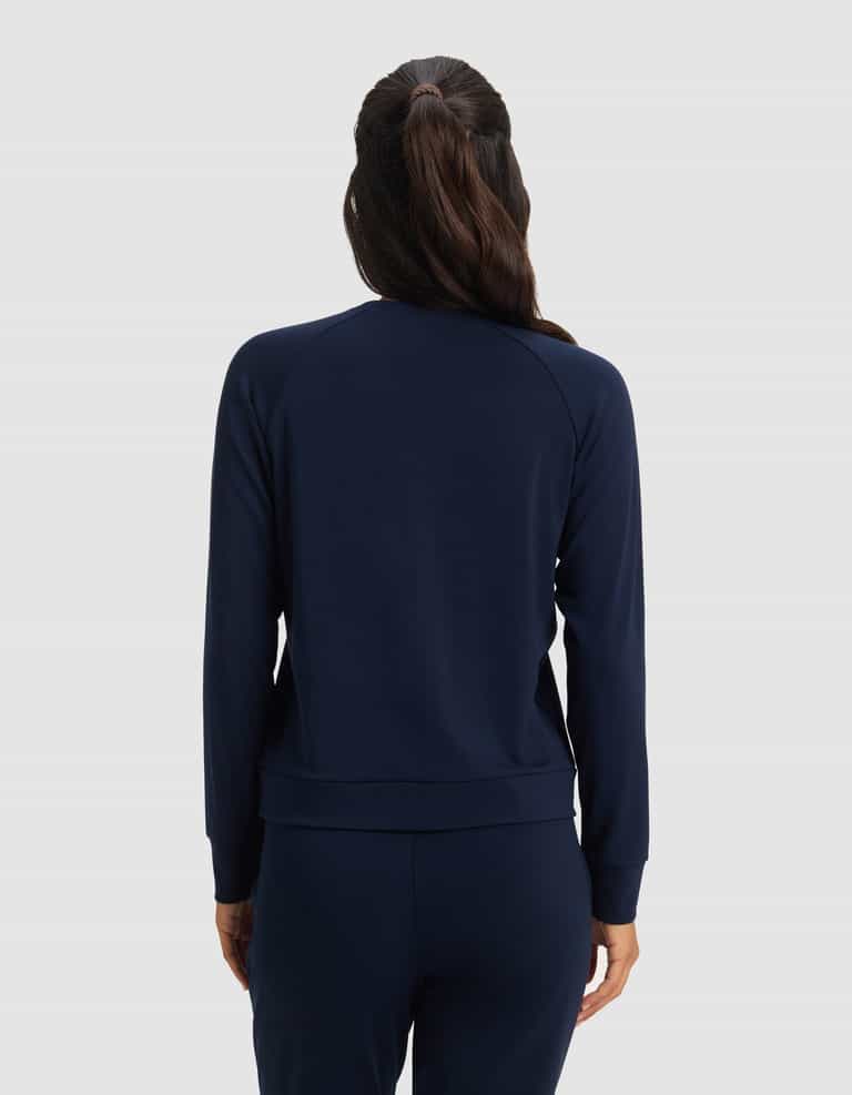 A woman with long brown hair in a ponytail is shown from the back, wearing Cozy Earth's Women's Brushed Bamboo Pullover Crew in navy blue against a plain light gray background.|Color:Navy
