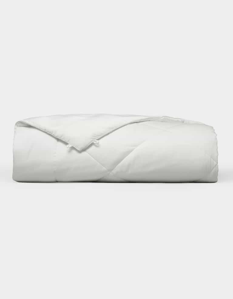 The Cozy Earth Bamboo Viscose Comforter, featuring a quilted design, is neatly folded and displayed against a plain white background. |Filling:Extra