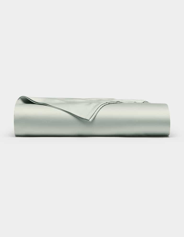 The Cozy Earth Bamboo Flat Sheet, in a light gray shade, is shown neatly folded with smooth edges on a plain white background.|Color:Laurel