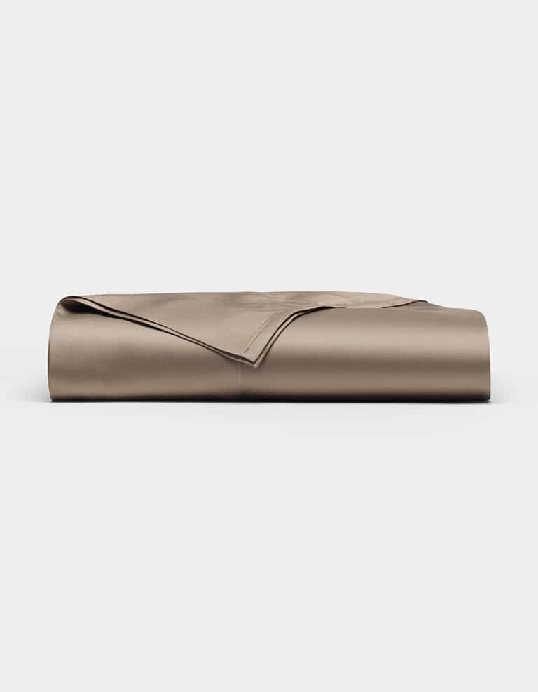 A neatly folded Bamboo Flat Sheet by Cozy Earth in taupe is displayed on a plain white background.|Color:Walnut