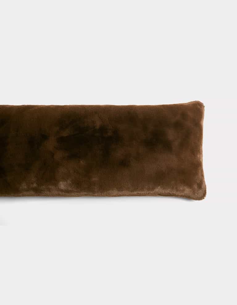 The Cozy Earth Cuddle Pillow is a long, rectangular, dark brown plush pillow with a soft, fuzzy texture, displayed on a plain white background.