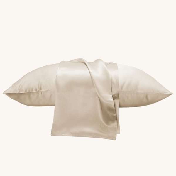 Luxury silk pillowcase with intricate embroidery, made from 100% mulberry silk, offering a soft, smooth feel for a restful night's sleep while adding an elegant touch to your bedroom decor.